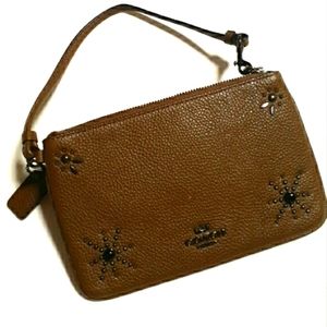 Coach brown pebble leather embellished wristlet